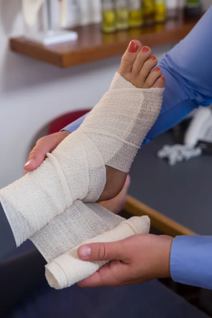 physiotherapist putting bandage on injured feet of 2023 11 27 05 24 08 utc